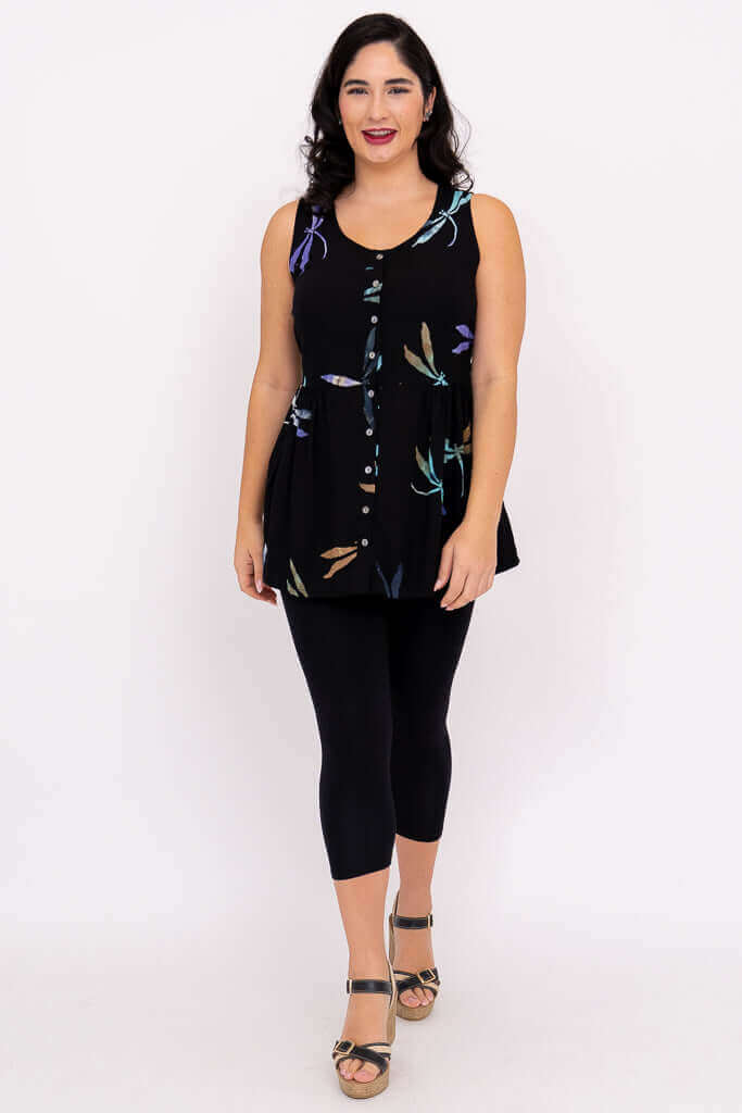 Woman walking in a black batik tank top with dragonfly pattern and button detailing