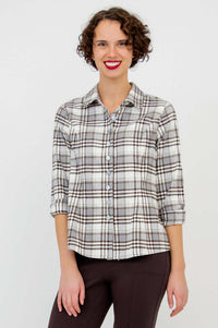 Model with sleeves rolled up in Alexis Top brown plaid shirt