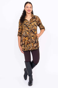 Full-length front angle of model in Celine Oversized Tunic with brown leggings and boots