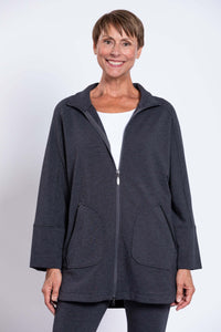 Woman wearing a charcoal grey zip-up jacket with large pockets and dolman sleeves, front view