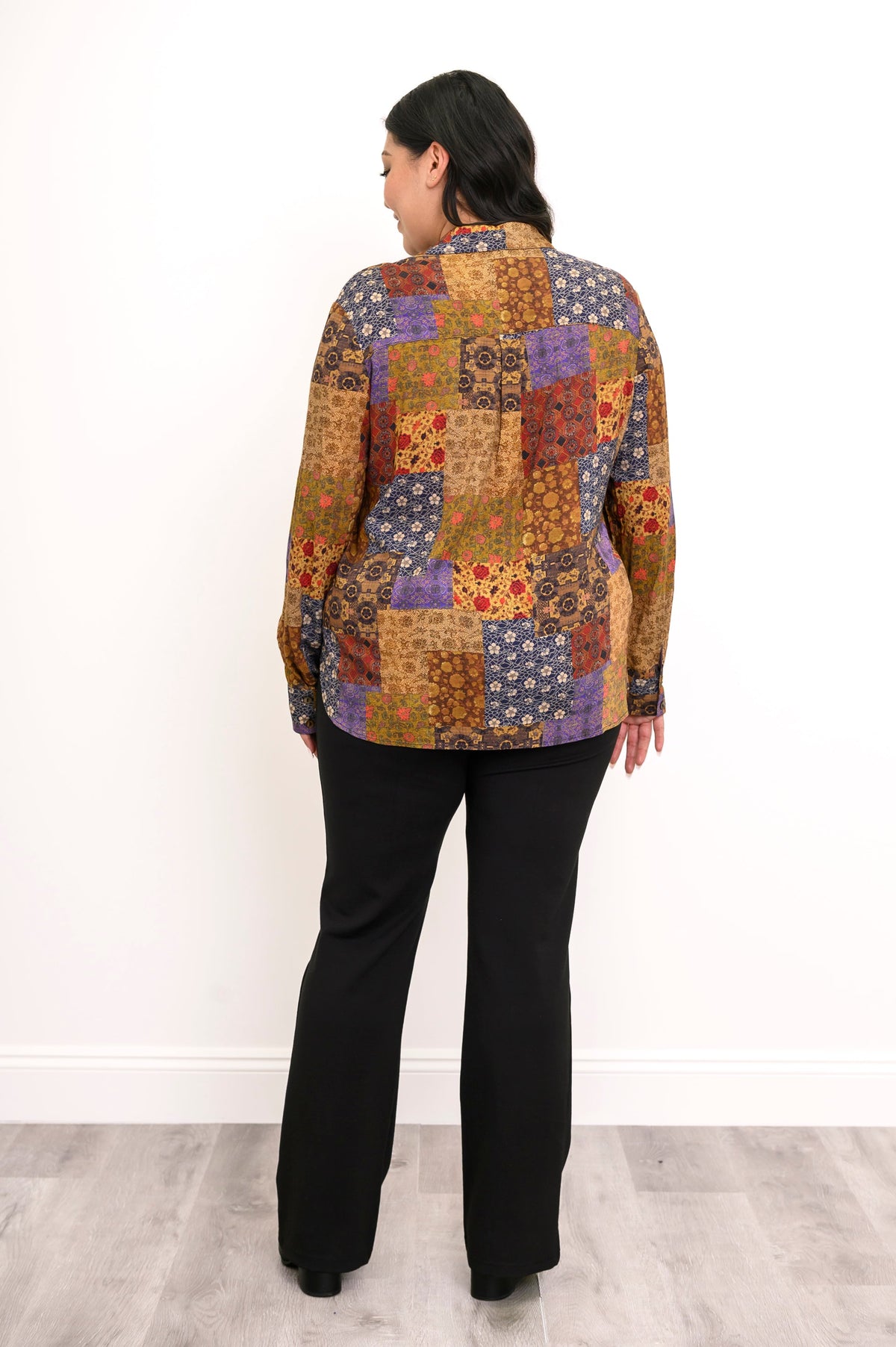 Rear view of a women's linen bamboo blend button-down shirt featuring a center back pleat layout