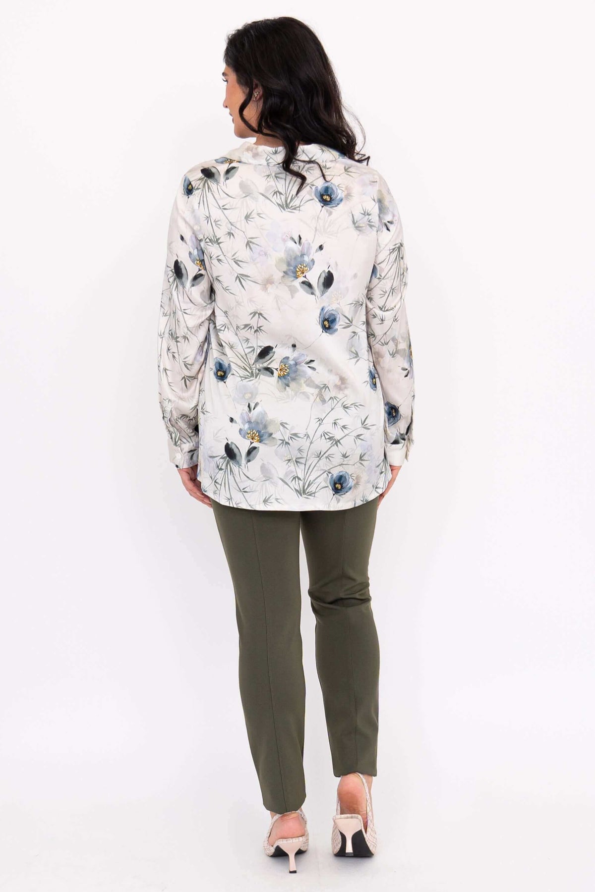 Back view of woman wearing Charlotte Blouse with blue floral print