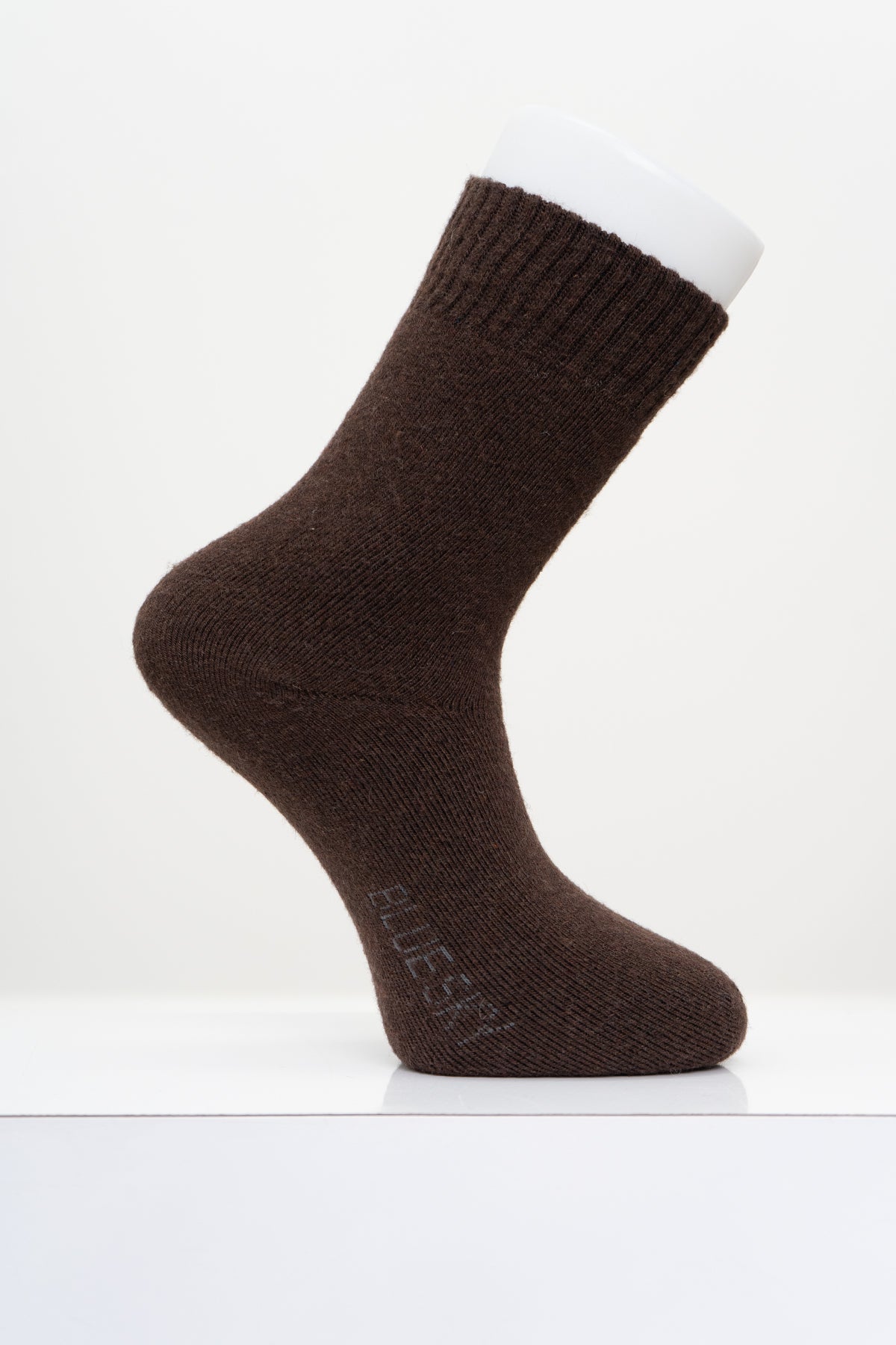 A single dark brown crew sock displayed on a white mannequin foot against a clean white background.
