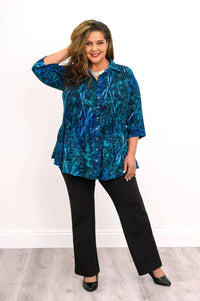 Woman posing with hand in hair, wearing the Cindy smocked button-down top