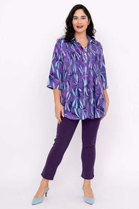 Model in Cindy violet dragonfly blouse and purple pants standing confidently
