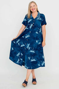 Woman displaying the flare of a blue dragonfly print short sleeve dress