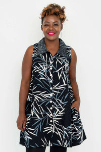 Model wears sleeveless black A-line button-up tank with white and blue leaf pattern and contrast collar