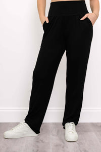 Front angle view of Clair black bamboo pants with hands in pockets