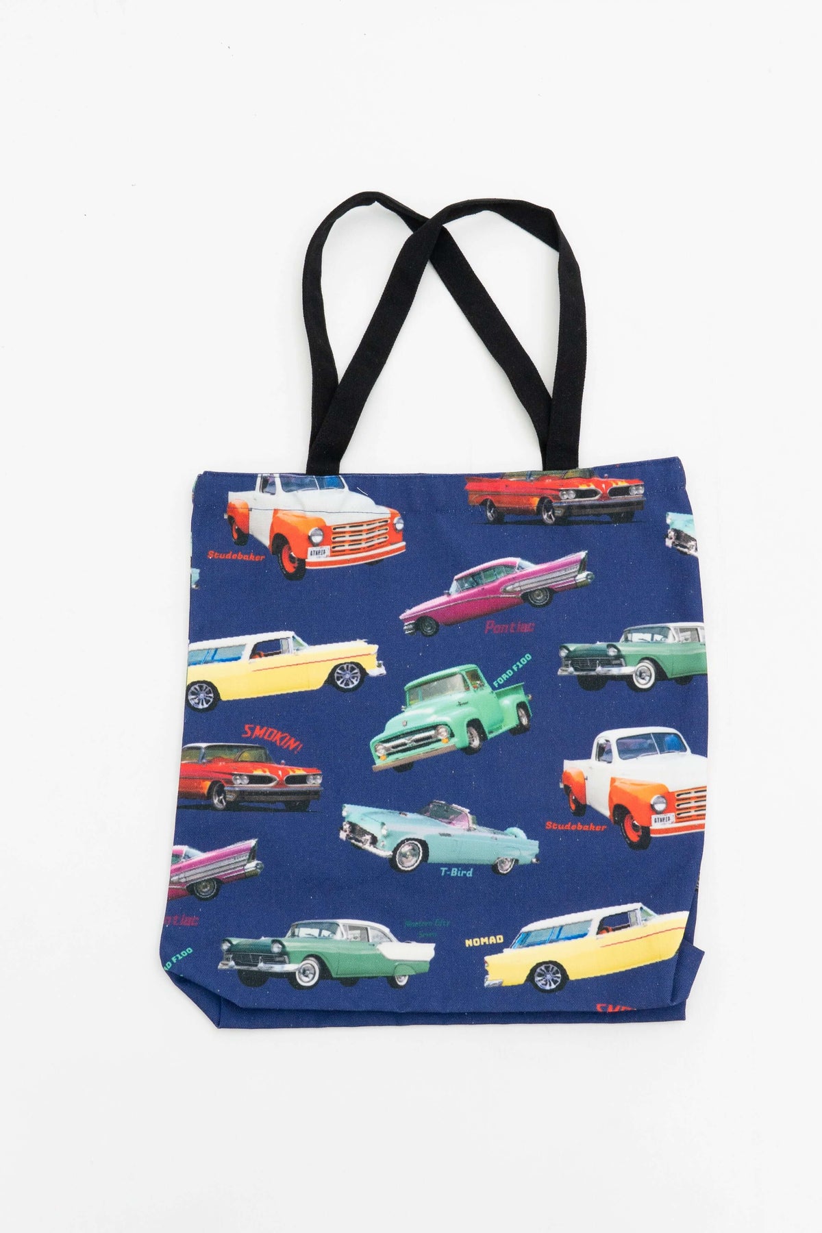 Reusable canvas tote bag with colorful classic cars print and black handles