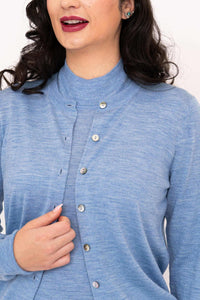 Close-up of blue Merino cardigan with buttons and ribbed collar detail