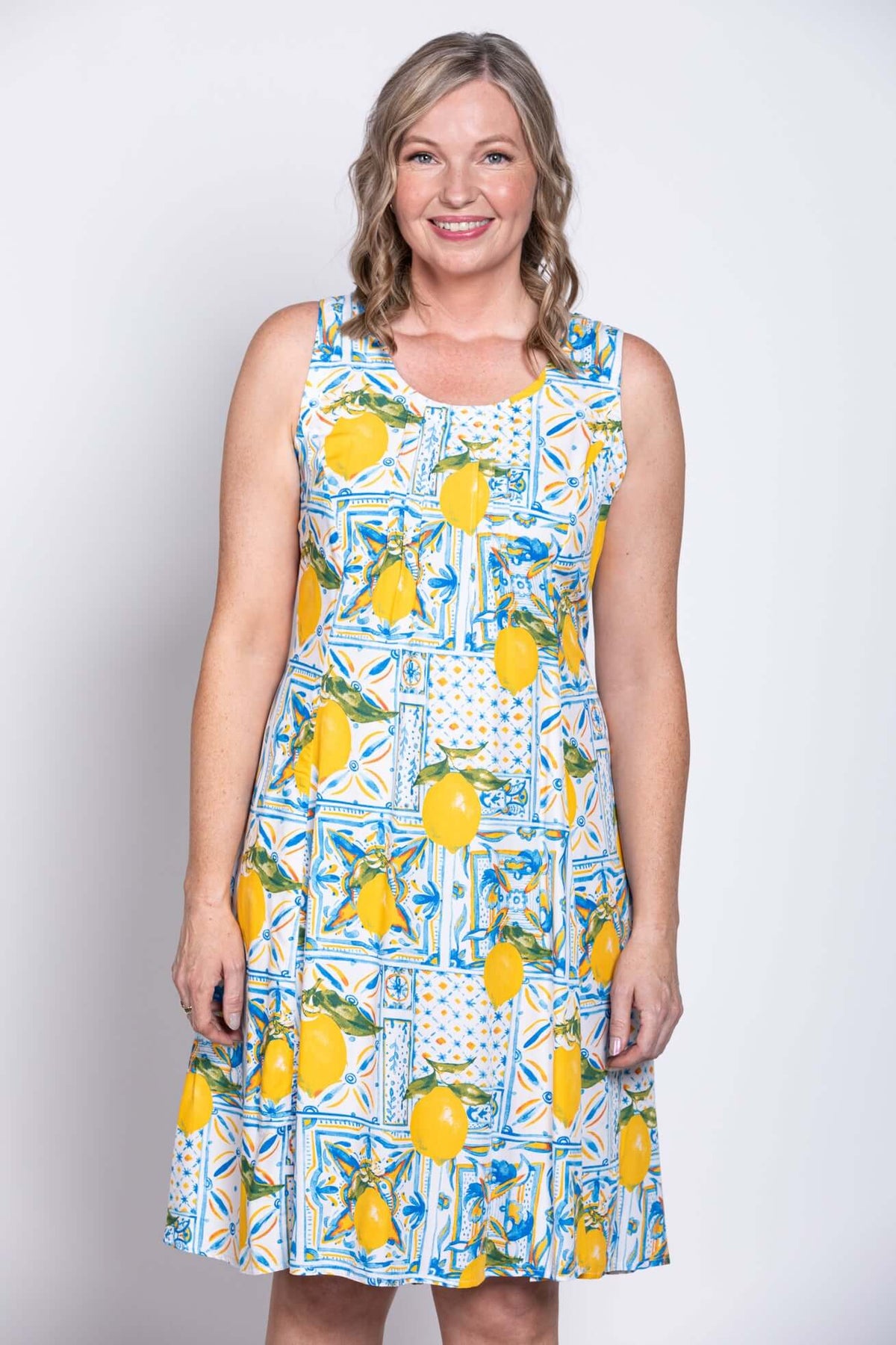Close-up front of sleeveless dress featuring lemon and blue tile design