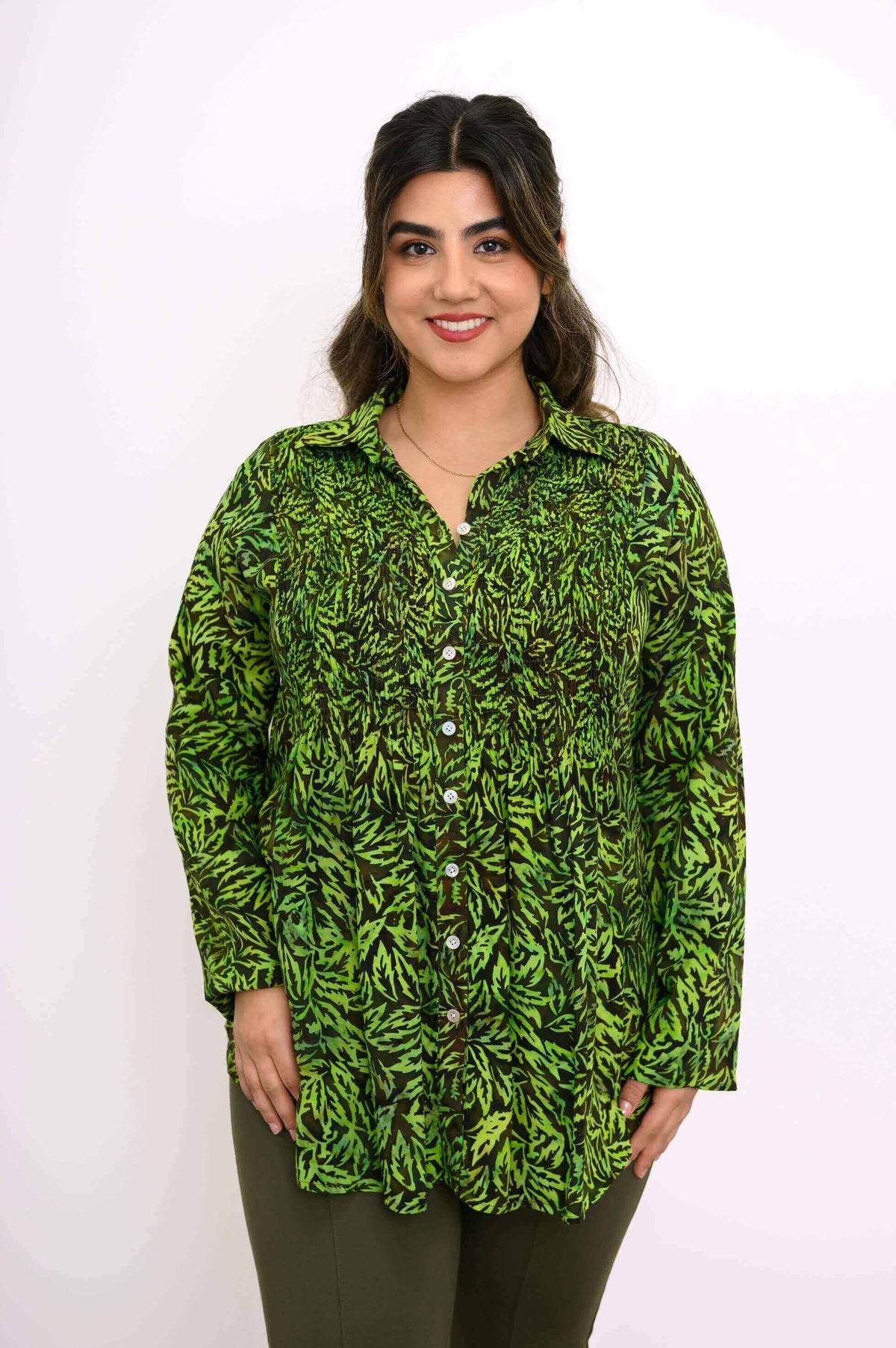 Woman wearing Cindy green leaf smocked top, close-up front view