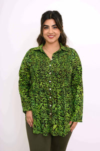 Woman wearing Cindy green leaf smocked top, close-up front view
