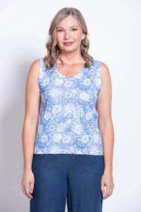 Close-up front view of a woman wearing a blue floral tank top