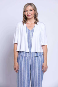 Close-up front view of woman in Landon cropped capri pants, matching top, and white cardigan