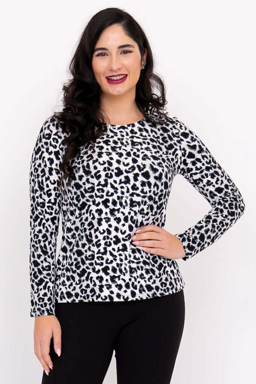 Close-up of woman in leopard print long sleeve tee, smiling