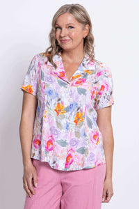 Close-up of another woman wearing the Samantha shirt with pink pants