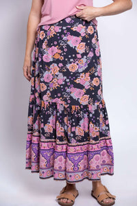 Close-up of Tibby floral maxi skirt with tiered sections and vibrant pink and purple prints