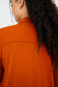 Close-up of back seam and collar detail on rust bamboo duster shirt