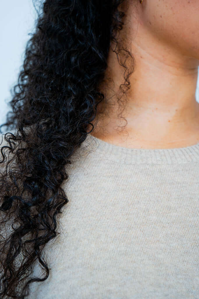Close-up of beige crew neck collar on wool cashmere sweater