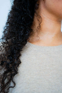 Close-up of beige crew neck collar on wool cashmere sweater