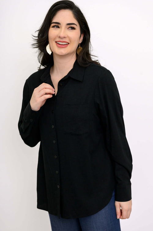 Close-up of woman in a black button-up shirt with spread collar and breast pocket