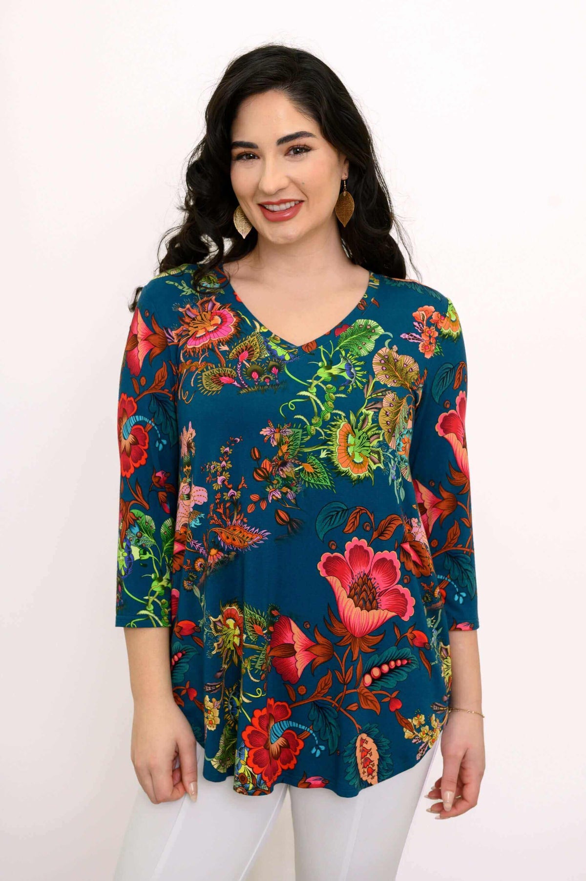 Close-up of a woman wearing a blue V-neck floral top, showing print details