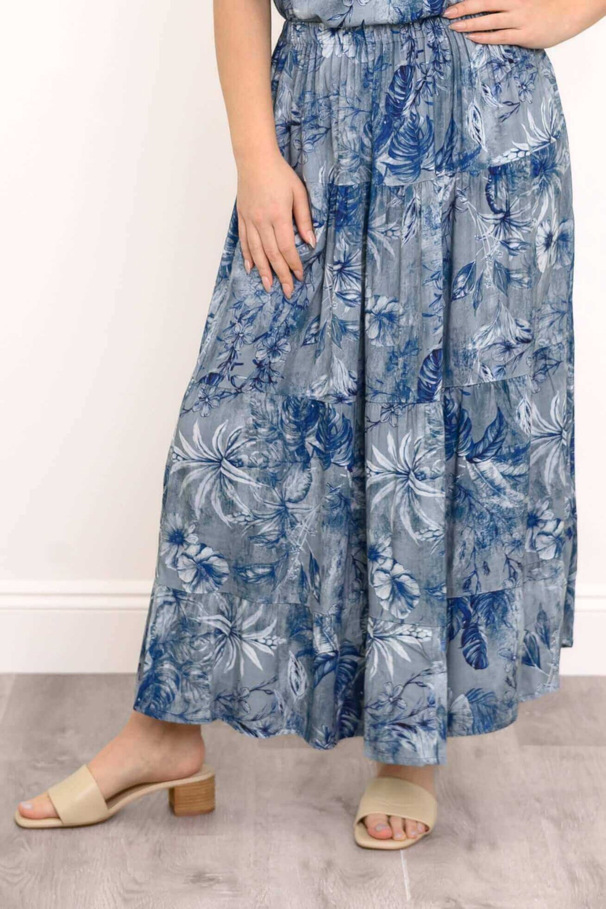 Close-up of blue floral tiered skirt with elastic waistband and pockets