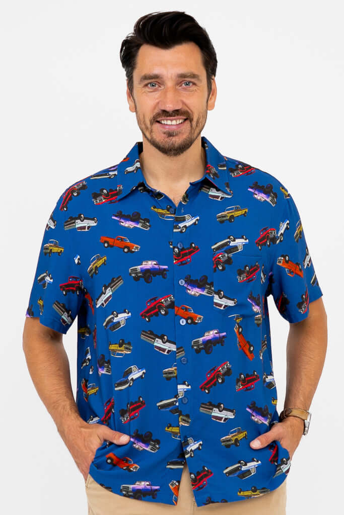 Close-up of man wearing a blue shirt with colorful monster truck print