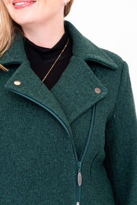 Close-up of the collar and zipper details on a dark green wool coat