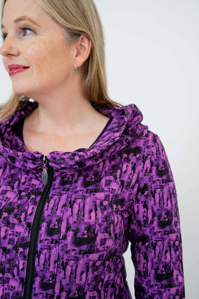 Close-up of collar and zipper on violet abstract print hoodie