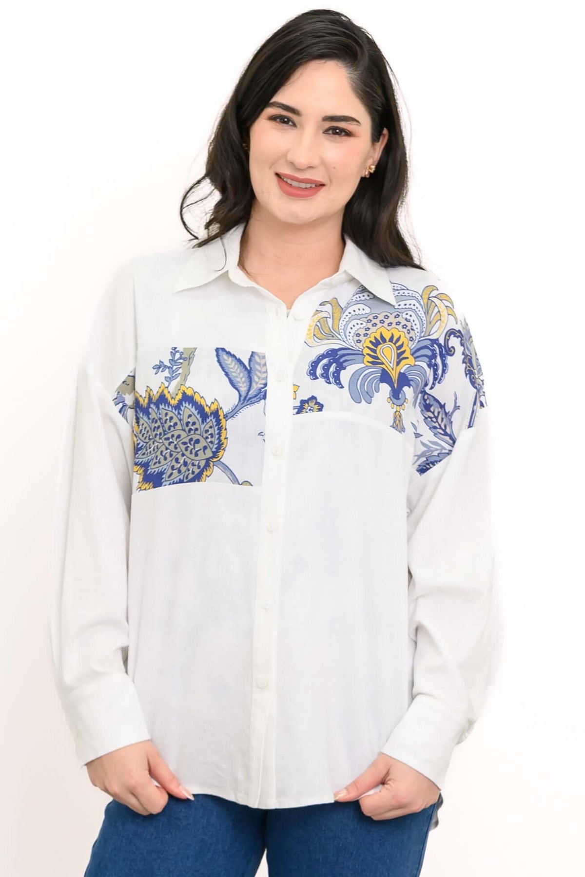 Close-up of model in white blouse with blue and yellow floral print yoke