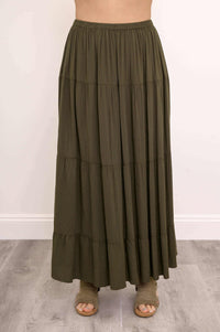 Close-up of olive green tiered maxi skirt focusing on elastic waistband and gathered tiers