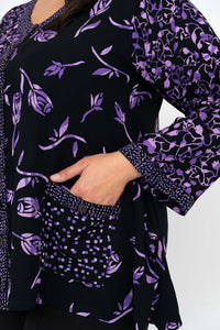 Close-up of the patterned pocket and sleeve details on the purple and black top