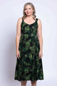 Close-up of black dress with green leaf design, sleeveless, empire waist