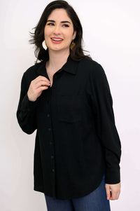 Close-up of a woman in a black spread-collar shirt with chest pocket
