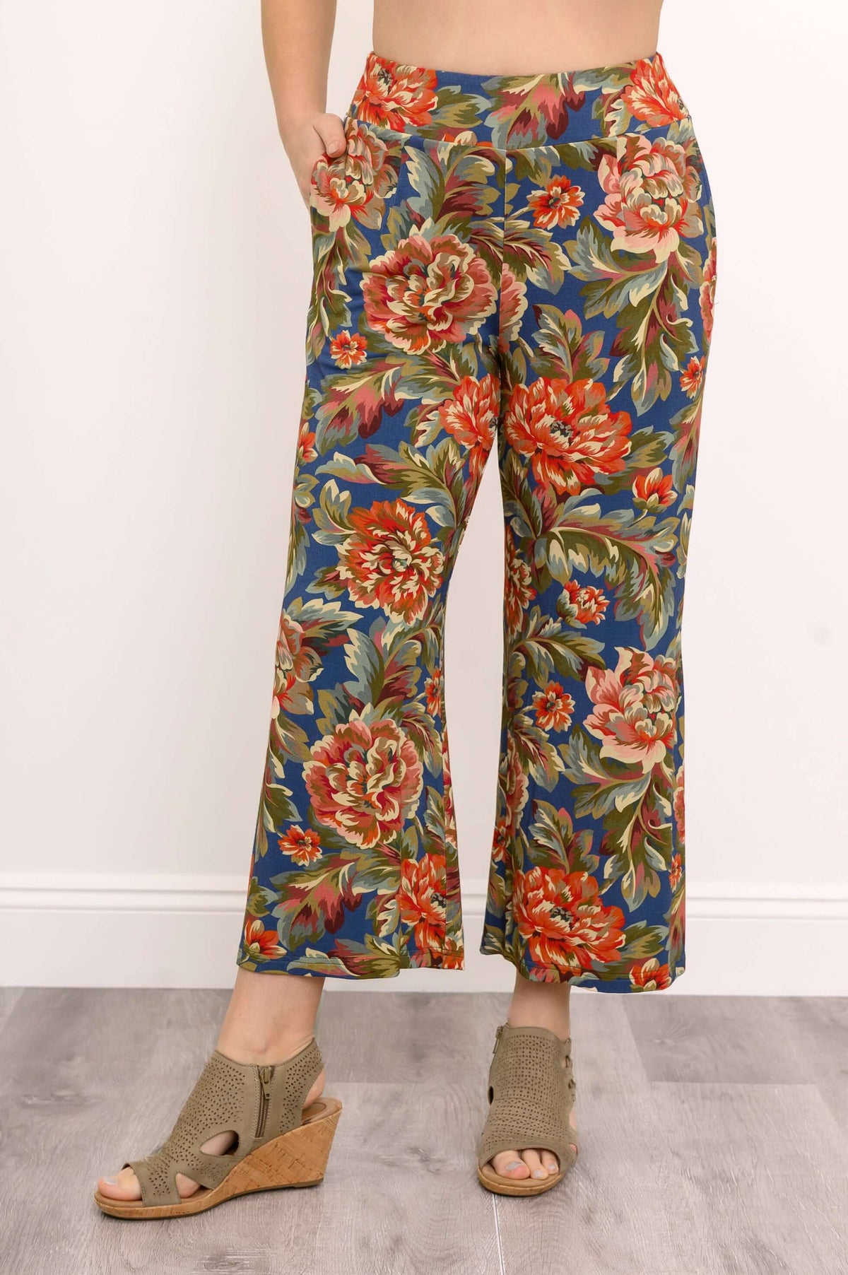 Close-up of wide leg floral pants with hands in pockets