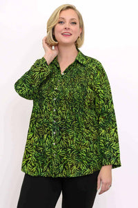 Woman wearing a green leaf print smocked top, close-up front view