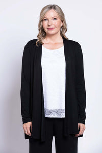 Close-up of woman in white lace tank top layered with black cardigan