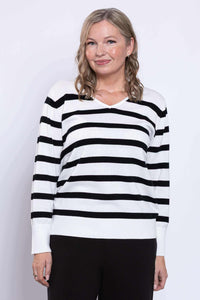 Woman wearing a black and tan Breton stripe V-neck sweater, close up