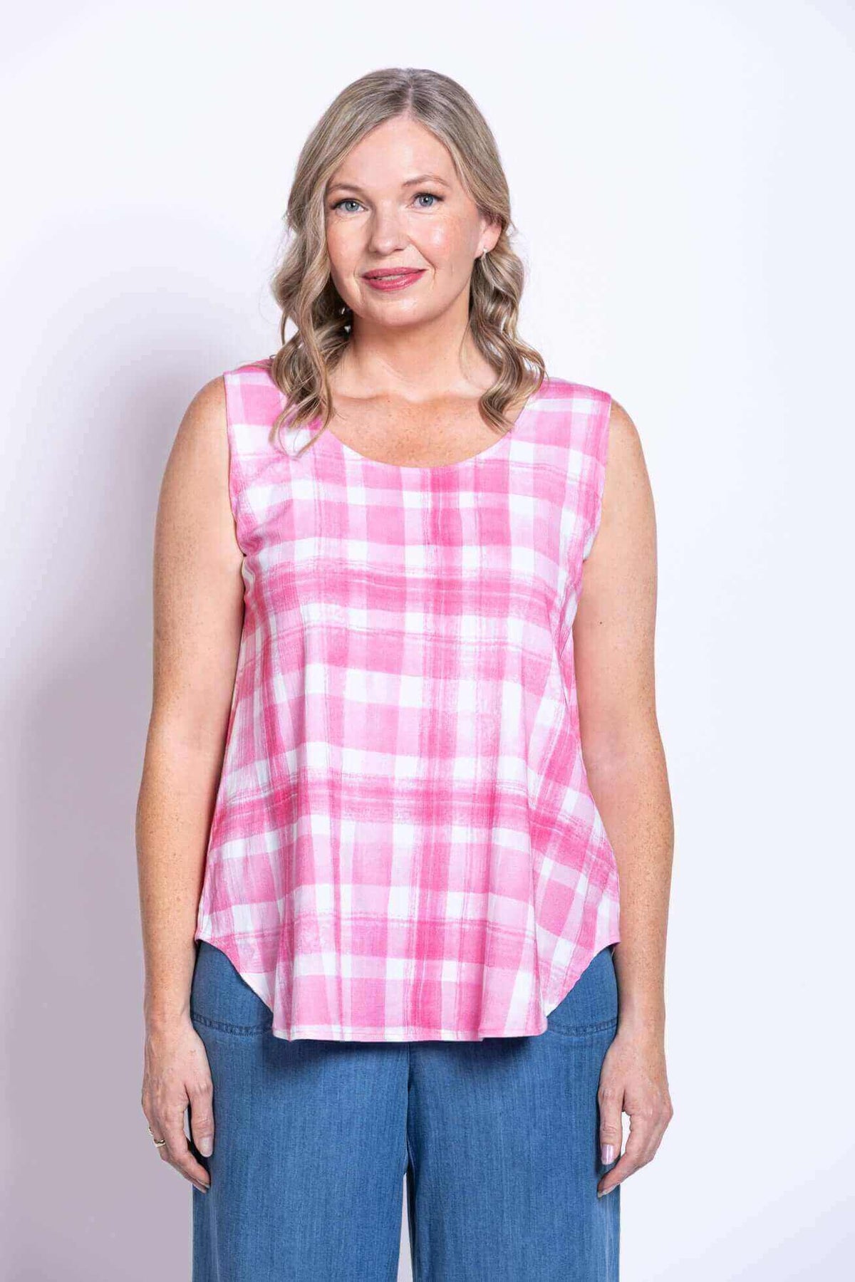 Close up of woman in pink plaid sleeveless tank top smiling