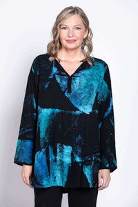 Front view closeup of woman wearing Kary Blouse in vibrant blue and black batik print