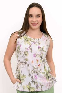 Woman wearing a sleeveless white floral botanical print tank top, closeup front view