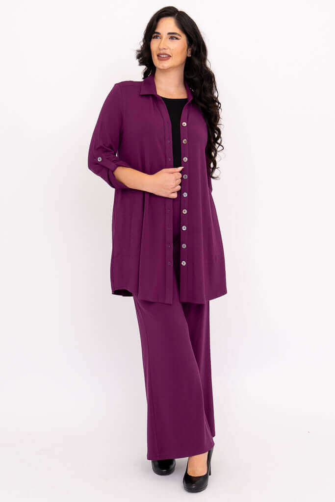 Woman with dark hair in a purple bamboo button-up tunic and wide leg pants