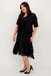 Side view of model in black mesh hem dress with black jacket