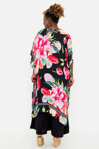 Rear view of model showcasing the full floral pattern on the Darcy evening wrap