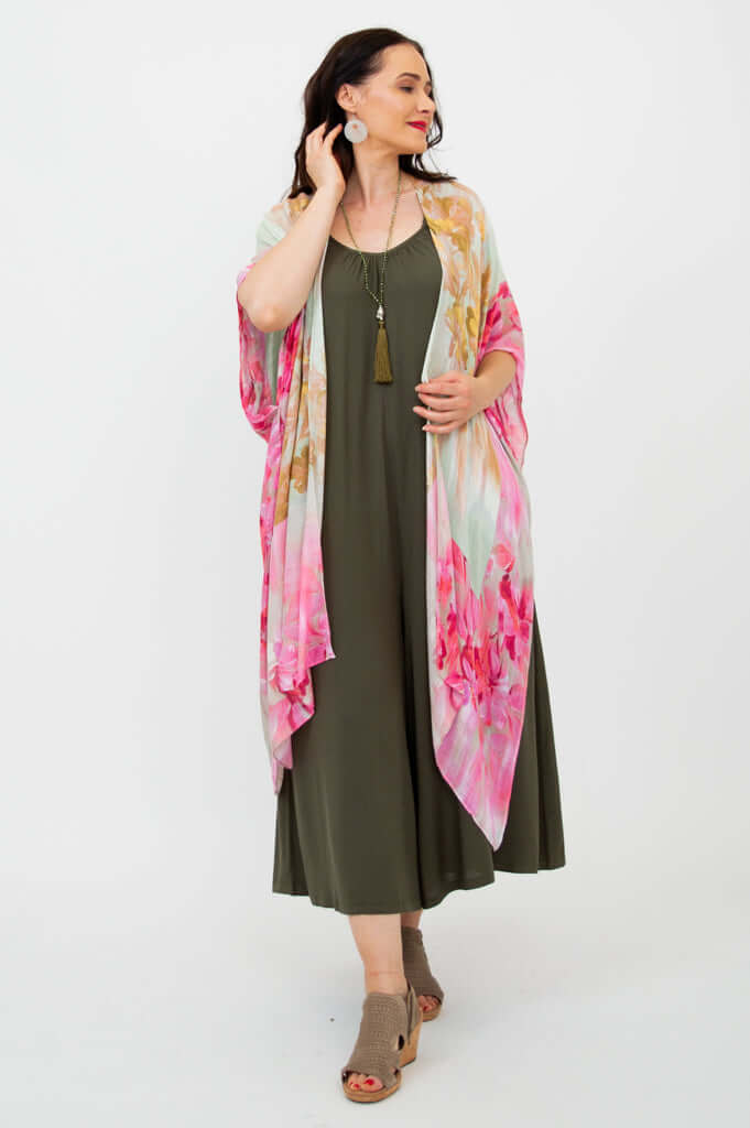 Woman wearing Darcy kimono wrap with floral design, touching earring