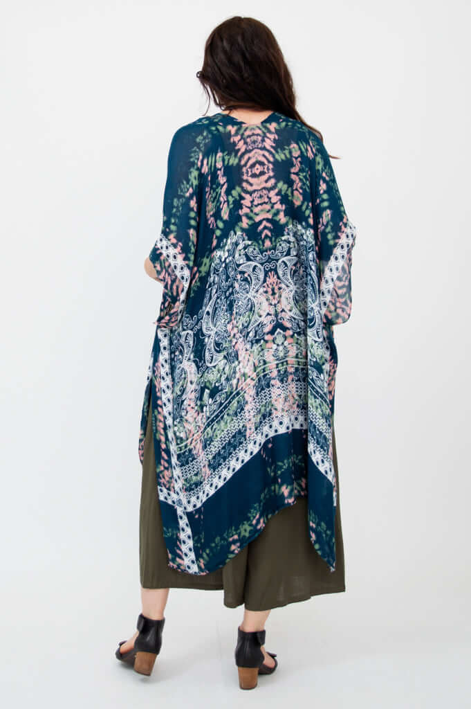 Woman wearing a Darcy kimono wrap over an olive dress, back view