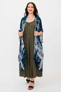 Woman wearing a Darcy kimono wrap over an olive dress, front view