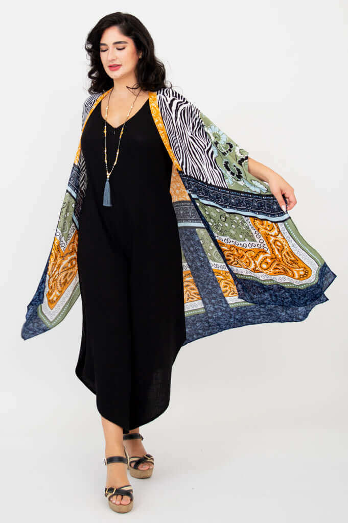 Woman in Darcy kimono wrap gracefully extending one arm, showcasing fluid hemline